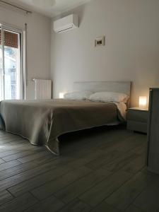 a bedroom with a bed and a large window at B&B Babbaro - camera con bagno privato in Castelcivita