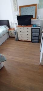 a bedroom with a bed and a dresser at St Davids & Moorfield Hotels Chapel Street in Llandudno