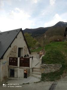 a house with a gate and stairs next to a mountain at Chalet Etxola in Ens