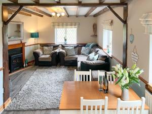 a living room with a couch and a table at Archways-e1223 in Winthorpe