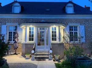 a house with a blue door and stairs at La Costonnerie in Leigné-sur-Usseau