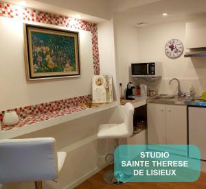 a kitchen with a counter with a sink and a counter top at Au Berceau de Bernadette in Lourdes