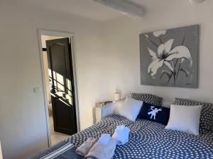 a bedroom with a bed with blue and white pillows at CHAMBRE d'HOTES POUR 2 PERSONNES in Peymeinade