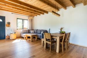 a living room with a table and a couch at Powidzka Ostoja in Salamonowo