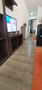 a living room with a flat screen tv on a table at Apartman MAŠA in Jagodina