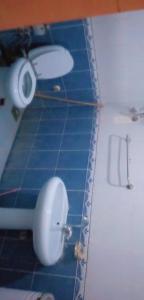 a white toilet in a bathroom with blue tiles at بيت سيدون السياحي in Aswan