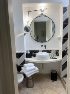 a bathroom with a sink and a mirror at Hotel Orsa Maggiore in Anacapri