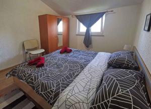 a bedroom with a bed with red shoes on it at Apartment in Sveti Lovrec/Istrien 27830 in Sveti Lovreč Pazenatički