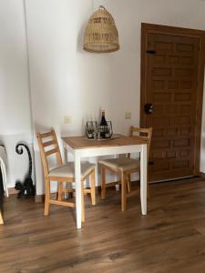 a dining room table and chairs and a door at Villa Casa Rosa, El Torcal in Almogía +26 photos