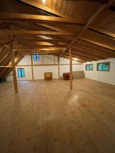 a large room with a wooden floor and wooden ceilings at Golden View Villa - Great place for vacations in Przesieka