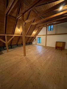 a large room with a wooden floor and wooden beams at Golden View Villa - Great place for vacations in Przesieka