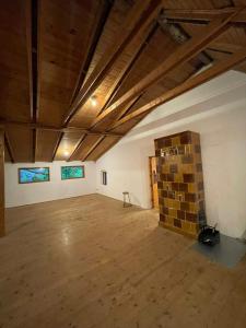 an empty room with a brick wall and wooden ceilings at Golden View Villa - Great place for vacations in Przesieka