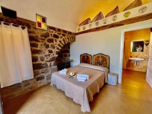 een slaapkamer met een bed en een tafel. bij Dammuso Civulia in Scauri