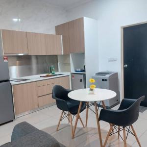 a kitchen with a table and two chairs and a table at TWIN GALAXY JB Homestay by SUMMER in Johor Bahru