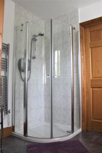 a shower with a glass door in a bathroom at Langdale Lodge in Lincoln