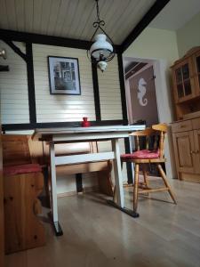 uma mesa de pingue-pongue num quarto com uma cadeira em FeWo Seepferdchen em Emden