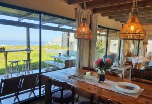 a dining room with a table and a view of the ocean at West Coast Seaside Getaway in Grotto Bay