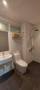a bathroom with a white toilet and a sink at TWIN GALAXY JB Homestay by SUMMER in Johor Bahru