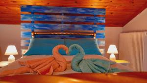 a bedroom with two swans on a bed at Katia's ATTIC in Acharavi