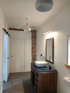 a bathroom with a sink and a mirror at Galician Rural Accommodation - La Casita in Lugo