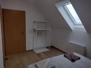 an attic room with a bed and a window at Pr' Hribar in Zgornje Gorje