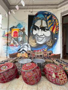 a wall with a painting of a woman at Cecilia Hostel in Cairo