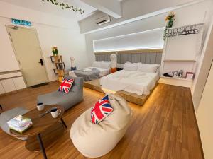 a living room with two beds and a table at Central of Sunway Town; 8 PAX in Petaling Jaya