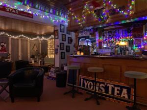 a bar in a restaurant with christmas lights at The Headlands Hotel in Scarborough