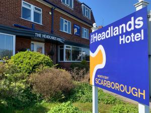 a sign in front of a hospitaladobe hotel at The Headlands Hotel in Scarborough