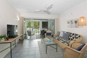 a living room with a couch and a table at The Palms Retreat - Alassio Beachfront Resort in Palm Cove