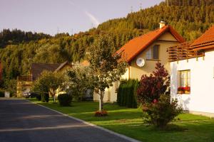 a house with an orange roof on the side of a road at Villapark Vlašky in Bešeňová