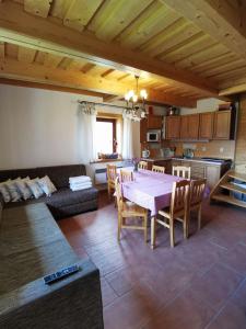 a kitchen and living room with a table and chairs at Drevenica Západné Tatry in Žiar