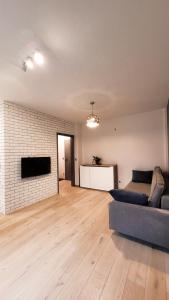 a living room with a couch and a flat screen tv at Green Terrace Big Family Apartment in Wrocław