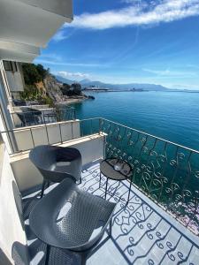 a balcony with chairs and a view of the water at Hotel La Lucertola in Vietri