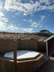 a bed sitting on top of a wooden deck at Víðilundur 17 in Varmahlid