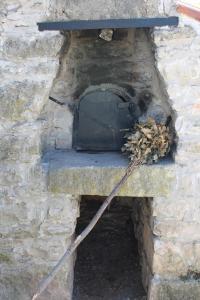 a stone oven with a black door on top of it at Apartment Fuma in Marčana
