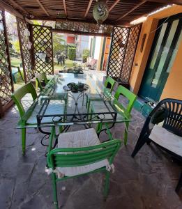 a glass table and chairs on a patio at Villa Brumar in Brebbia