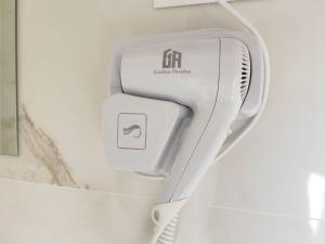 a hair dryer is attached to a wall at HOSTAL GOLDEN 21*** in Madrid