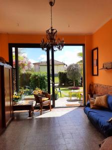 a living room with an open door to a patio at Villa Brumar in Brebbia