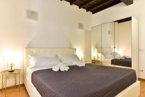 a bedroom with a large bed with towels on it at Elite Rome apartments 3 in Rome