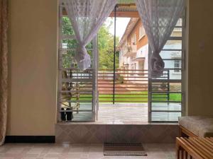 a large window with a view of a patio at Town Retreat Moshi in Moshi