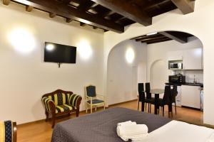 a room with a bed and a table and chairs at Elite Rome apartments 3 in Rome