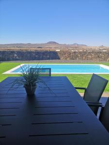 a table with a laptop sitting on top of it at Villa Los Volcanes in Lajares +47 photos