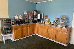 a food counter in a restaurant with a refrigerator at Days Inn by Wyndham Hannibal in Hannibal