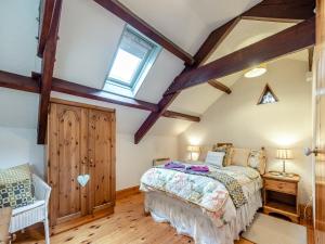 a bedroom with a bed and a window at Ty Berllan - Oab in Gowerton
