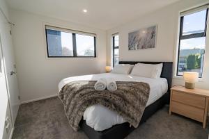 a bedroom with a large bed with two towels on it at King bed on Hagley Park corner in the CBD in Christchurch