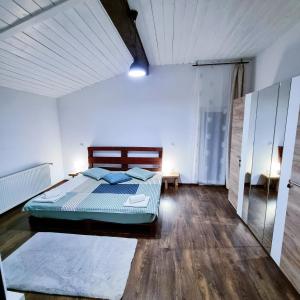 a bedroom with a bed in the middle of it at Cabana Căsaru in Colibiţa