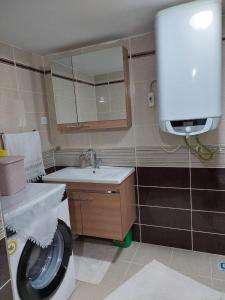 a bathroom with a washing machine and a sink at MEVA APART in Rize