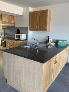 a kitchen with a sink and a counter top at Het Zonnetje Zonnebeke in Zonnebeke