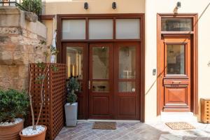 a wooden front door of a house with plants at Hanim Boutique Hotel in Chania Town